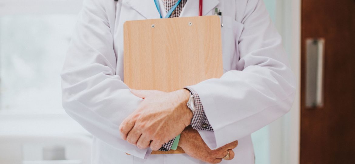 Physician holding a clipboard with medical information