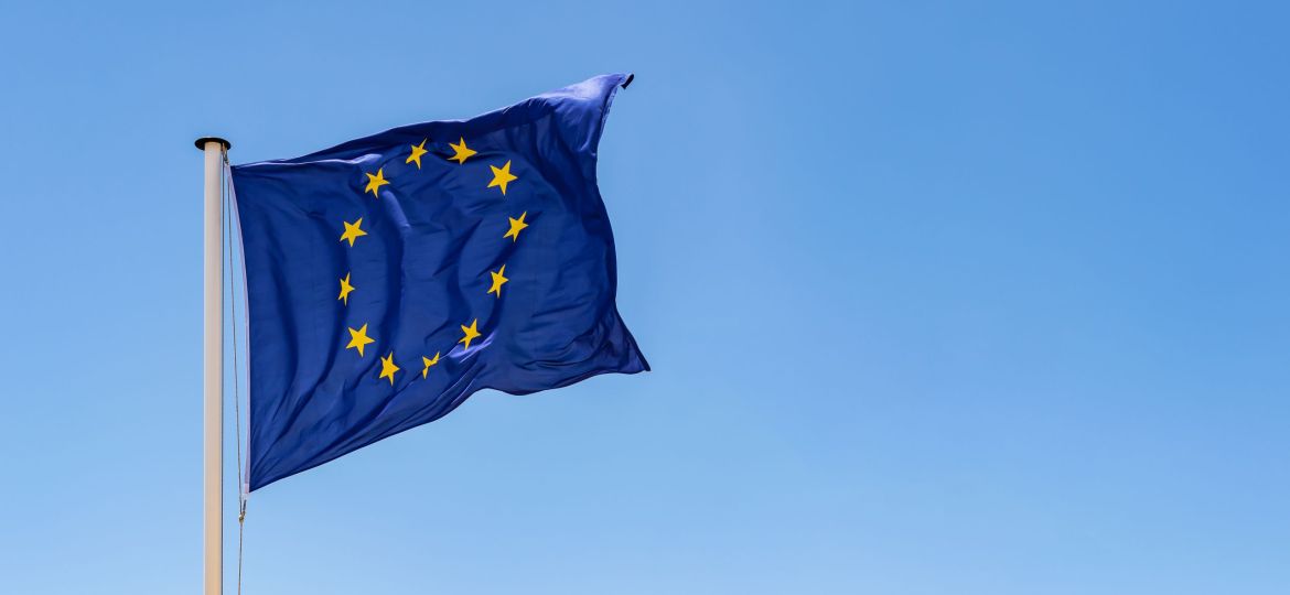 European Union Flag waving in the wind with a clear blue sky background